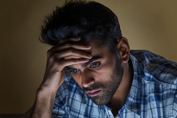 sad man thinking at home	