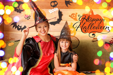 Mother with little daughter celebrating Halloween at home