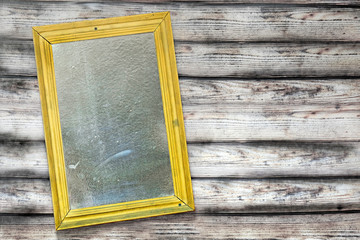 Vintage interior with a fake mirror in a worn yellow frame. Prepared scenery for the performance in...