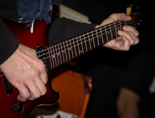 Fototapeta na wymiar Playing guitar close up photo