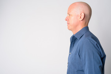 Closeup profile view of mature handsome bald businessman