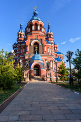 Fototapeta na wymiar Irkutsk, Russia - October 8, 2019: Beautiful view of the church of Our Lady of Kazan with trees
