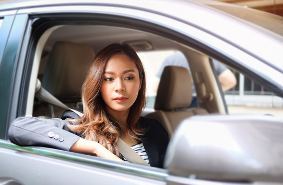 Close Up Portrait Of A Young Business Woman Exiting A Car