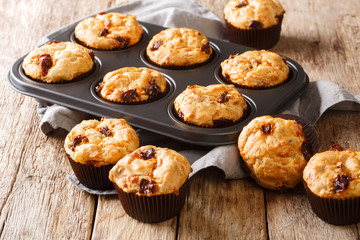 Obraz na płótnie Canvas Light vegetarian muffins with dried tomatoes close-up in a baking dish. horizontal