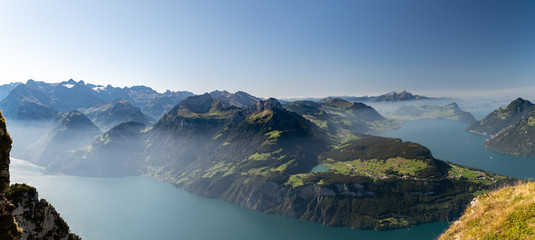 Naklejka na ściany i meble Panoramic view on Swiss Alps and on Lake Lucerne from Fronalpstock peak above the village of Stoos