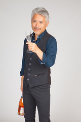Hombre de mediana edad de origen japonés con una copa de Champagne vacía