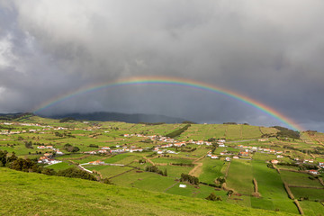 Rainbow over a village on Ilha do Faial, Azores, Portugal