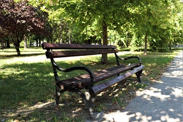 wooden bench with iron handles in the park