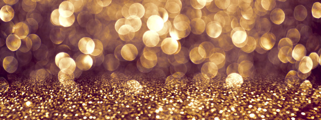 Shining background with shiny sparkling bokeh and magic golden glitter