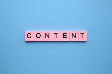 Content word wooden cubes on blue background