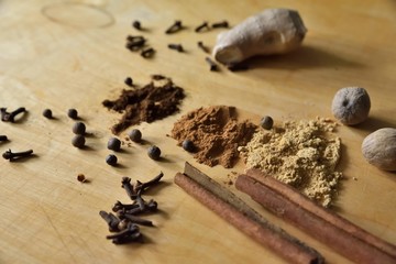 Lots of spices on wooden background and with mortar and spice, spice preparation concept