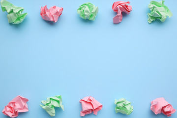 Multi-colored crumpled paper balls on a blue background.
