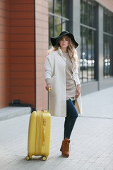 Travel concept. Young tourist woman walking.