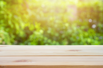 Perspective wooden table on top over blur natural background, can be used mock up for montage products display or design layout.
