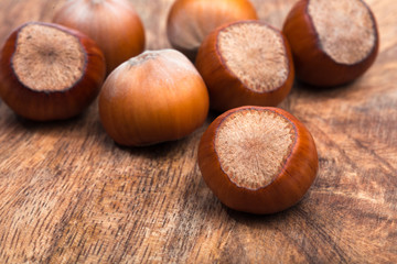 close up of hazelnuts on wooden table .