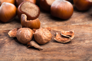 close up of hazelnuts on wooden table .