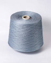 bobbin of yarn on a white background. Side view.Textile reel on isolated white background.