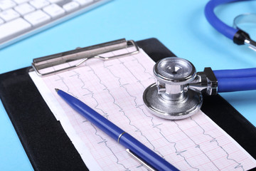 keyboard and Medical stethoscope lying on cardiogram chart closeup. Medical help, prophylaxis,...
