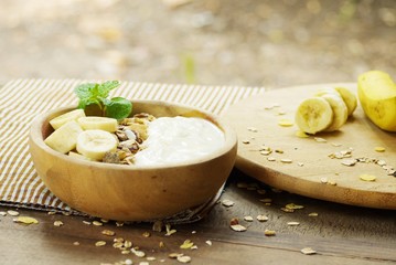 Bowl  of Yoghurt with fruits and Granola for Healthy body , Healthy home made food image  on wooden texture 