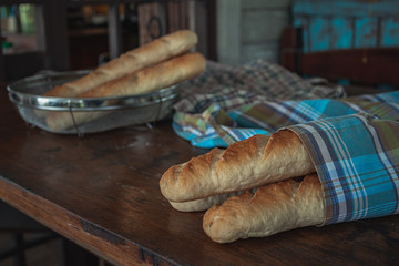 Baguette on a wooden table.
