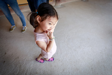 Cute little asian girl standing outside