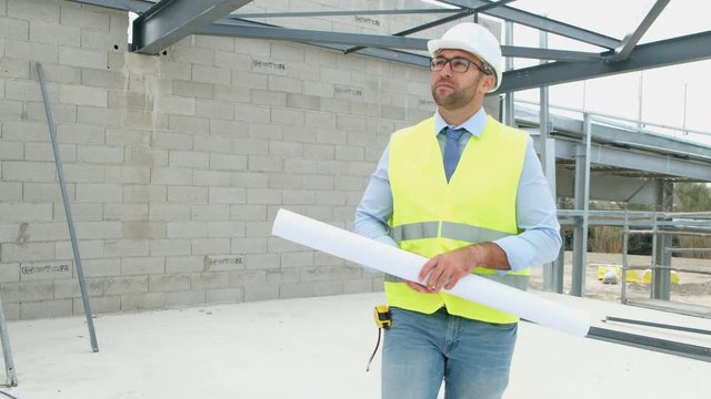 portrait of handsome foreman construction worker on a industrial building industry construction site 4 K 50 fps footage