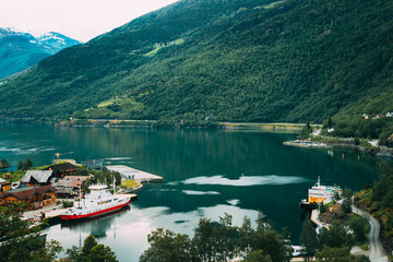 Fototapeta na wymiar Flam, Norway. Touristic Ship Boat Moored Near Berth In Sognefjord Port. Aerial View In Summer Evening. Norwegian Longest And Deepest Fjord. Famous Natural Norwegian Landmark And Popular Destination