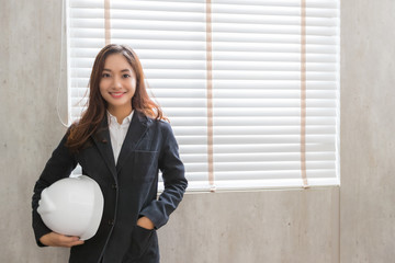 Portrait of beautiful young asian engineer woman or technician is smiling in the office, Concept of woman success