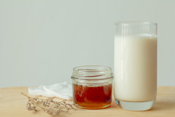 honey and milk on wood table.