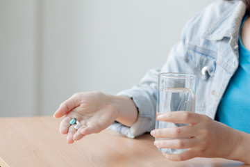 Women are taking medicine and holding a glass of clean water. health care concept.