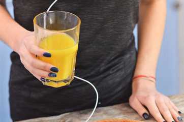 Young woman drinking fresh orange juice indoors