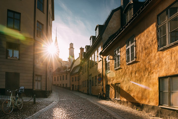 Stockholm, Sweden. Sunshine During Sunset Above Traditional Stockholm Street. Beautiful Street In Sunny Summer Evening. Cozy Side Street