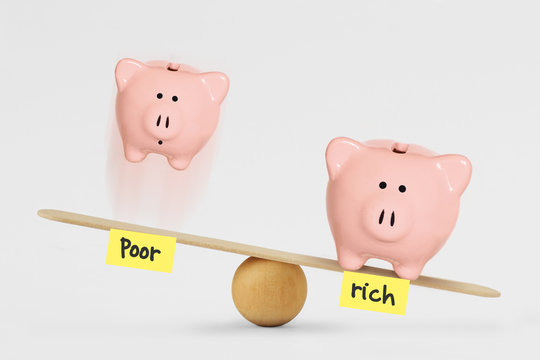 Oor And Rich Piggy Bank On Balance Scale - Concept Of Social Inequality Between Rich And Poor