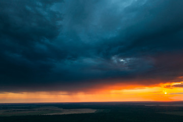 Aerial View Of Sunset Sky Above Green Forest Landscape In Evening. Top View From High Attitude In Summer Sunrise