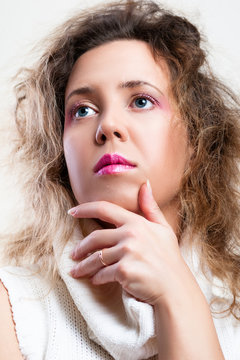 Make up photo of a beautiful disheveled curly hair fashion model woman with red and pink cosmetics