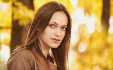 Autumn portrait of a beautiful woman in the park