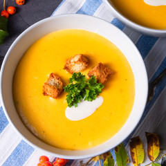 Delicious pumpkin soup with croutons and coconut milk