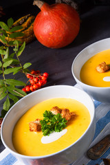 Delicious pumpkin soup with croutons and coconut milk