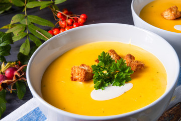 Delicious pumpkin soup with croutons and coconut milk