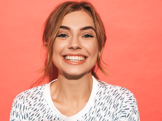 Young beautiful woman looking at camera. Trendy girl in casual summer shirt clothes with natural...