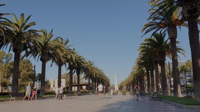 Promenade at morning in Salou beach with people walking. Tarragona