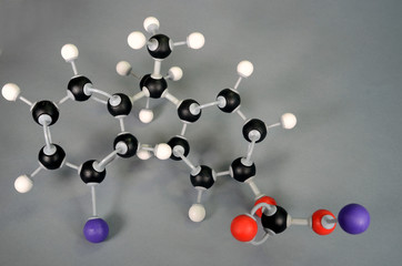 Molecule model of polycarbonate as used in protection glass. White is Hydrogen, black is Carbon, red is  Oxygen. Lilac marks the beginning and end where a new similar molecule is attached.