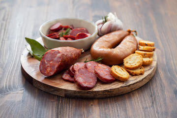 typical smoked portuguese sausages on wooden board