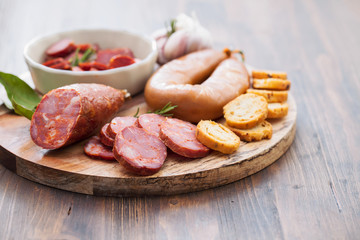 typical smoked portuguese sausages on wooden board