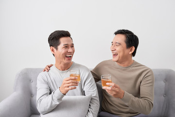 Men talk concept. Two young male friend gathering, chatting and eating at home.