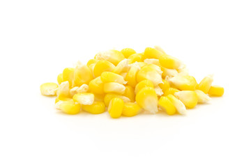 Piles of fresh corn kernels close-up isolated on white background