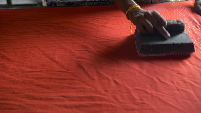 Block Printing - A skilled worker is printing the fabric with blocks. 