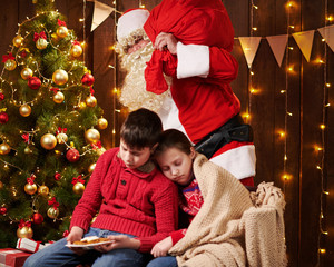 The children waited a long time for Santa, now they fell asleep and Santa quietly goes to the Christmas tree to give presents - Merry Christmas and Happy Holidays!