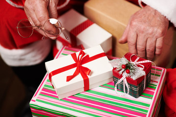 Close-up of Santa hands with many gifts - Merry Christmas and Happy Holidays!