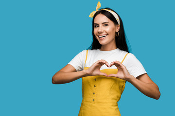 happy young woman showing heart with hands isolated on blue